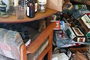 Junk piled up near a table and chair needing Hoarder Clean Up in Folsom, CA