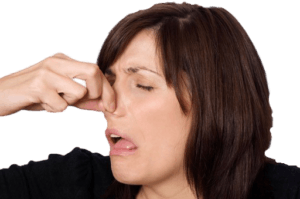 Woman pinching nose due to odor