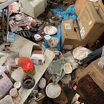 House with Trash on Floor for Hoarder Cleanup in Modesto, CA